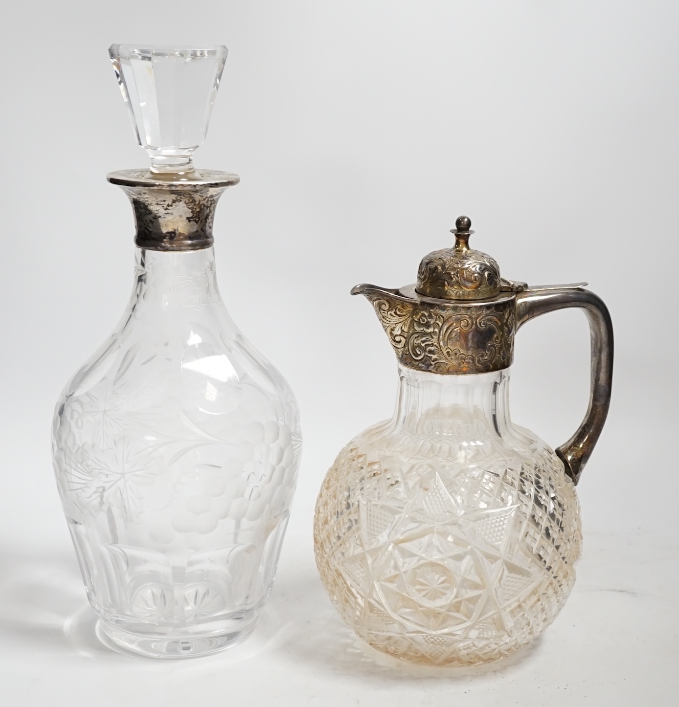 A 1960's silver collared cut glass decanter with stopper, 29cm and a white metal mounted cut glass decanter.
